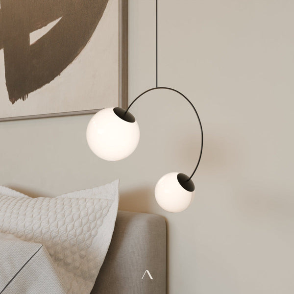 Colmar Pendant Light — a geometric iron pendant with two opal glass globes at each end of an arched tube