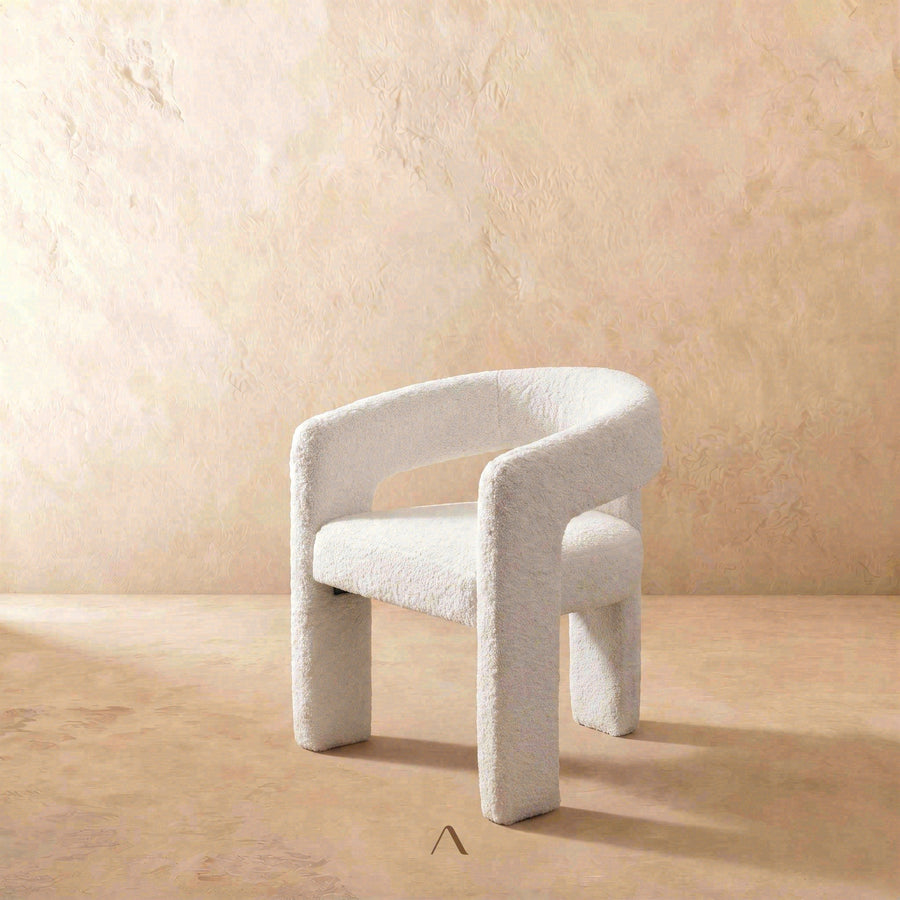 Vulo Chair — a curved backrest in plush fabric